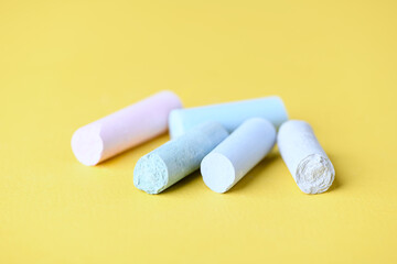 Soft pastels on yellow background. Close up. Copy space.