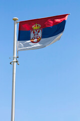 Serbian flag on the pillar waving on the wind. Adobe RGB color space.