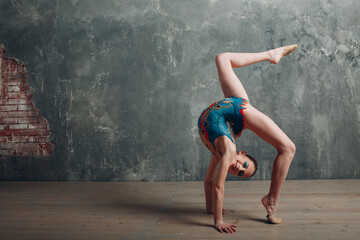 Young girl professional rhythmic gymnastics training at studio.