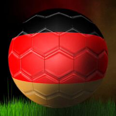 Fototapeta premium Soccer ball of the German team, on a black background above the grass