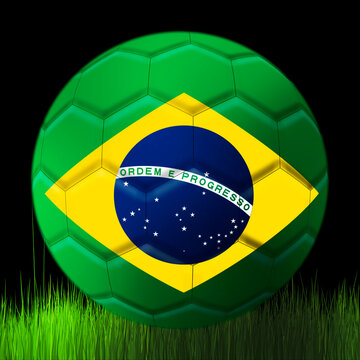 Soccer ball of the Brazil
team, on a black background above the grass