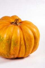 Whole fresh orange big pumpkin on white background, closeup. Organic agricultural product, ingredients for cooking, healthy food vegan.