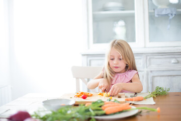 Family preparing a healthy meal in the kitchen at mediterranean home.
