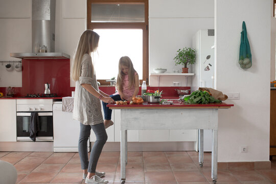 Mother and daughter preparing a dinner of vegetables
