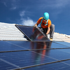 Man installing solar panels - 438706496