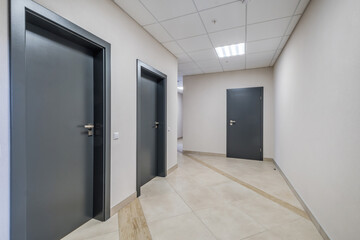 long white empty corridor in interior of entrance hall of modern apartments, office or clinic