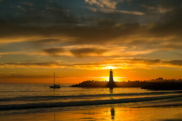 Fototapeta na wymiar The Walton Lighthouse at the Santa Cruz, CA harbor at sunset.
