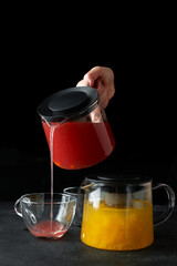 Two fruit teas yellow and red, on black