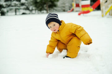 Fototapeta na wymiar Baby boy in snow outside