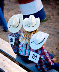The young cowboys on the bench waiting to ride during adventures of The West in Robertson, Wyoming...