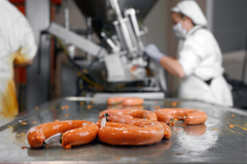 Sausages production at the meat processing factory. High quality photo.