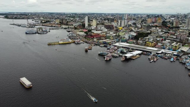 Boats navigate by the Negro River near the Port of Manaus, Amazon region, Brazil.