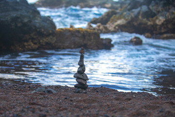 Stack of pebbles stone against sea background for spa, balance, meditation and zen theme.