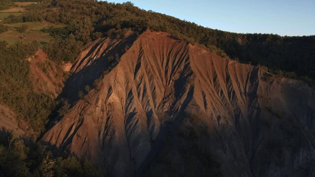 Aerial view of a beautiful ravine in the Colli Piacentini area at dawn near Bettola, Emilia-Romagna, Italy.