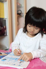 Japanese girl doing homework at home