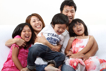 Fototapeta premium A happy Japanese family relaxing in the living room 