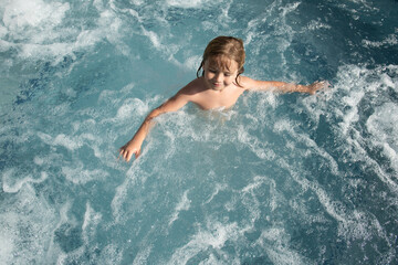Funny child enjoying the summer in the pool. Hot tub spa.