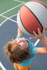 Close up portrait of a cute little child play basketball. Childhood and sport concept.