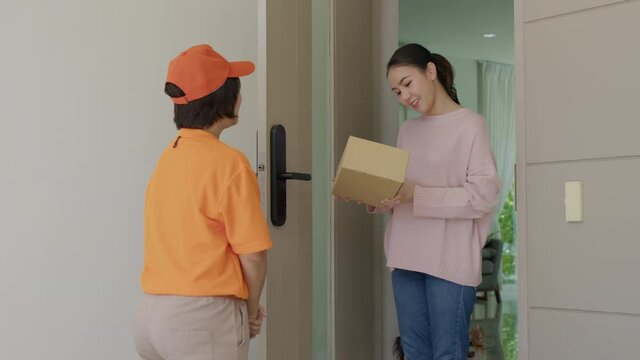Asia people female girl success pickup free fast express good postal post mail support from e-shopping retail order online e-commerce store postmate worker carry container at door home city life.