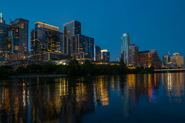 Fototapeta premium Downtown Skyline of Austin, Texas in USA from view at sunset. Reflection in water.