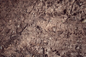 Wheel tracks on the soil road background or texture