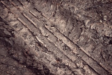 Wheel tracks on the soil road background or texture