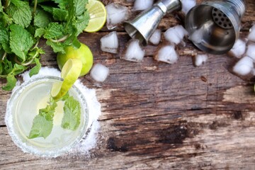 Making a margarita cocktail lime salt and mint leaves