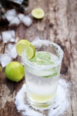 Fototapeta premium Making a margarita cocktail lime salt and mint leaves