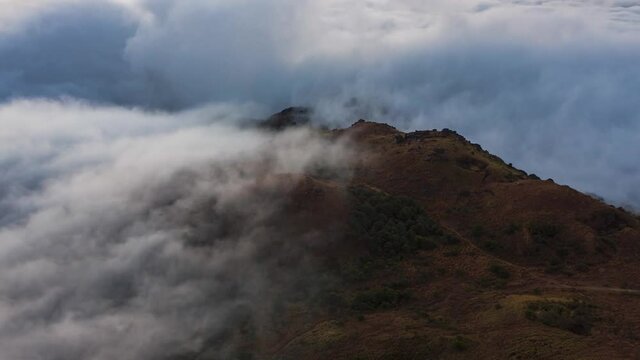 Motion Timelapse Of Clouds On The Mountain Peak In Tai Mo Shan, Hong Kong Blown By The Wind - close up. Hill fog forming over the mountains. Parallax drone shot. Surreal cloud movement. Hyperlapse