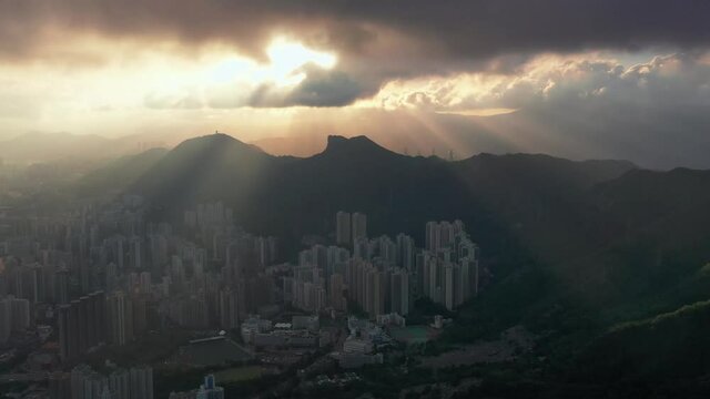 city scape fire sky vibrant sunset, thick clouds passing into the city time lapse in Tai Po, Hong Kong. parallax time lapse shot of modern skyline office, condo before sunset and city light.