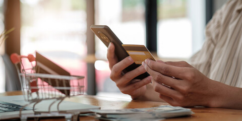 Online payment,Man's hands holding smart phone using credit card for online shopping