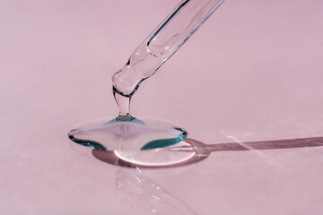 A drop of cosmetic oil falls from the pipette