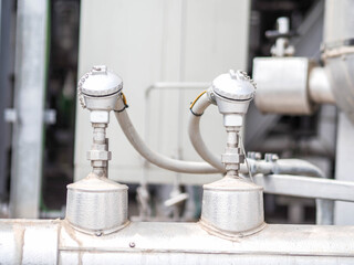 Temperature sensor for measuring instrument close up in industry zone at power plant.