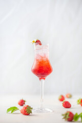 Strawberry liqueur with ice in a glass.