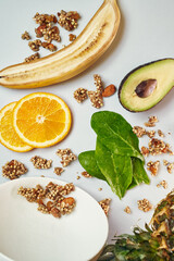 fruit mix with granola. spinach, avocado, pineapple, orange. raw vegan smoothie