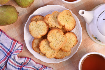 Round rusks with pesto sauce flavor on white plate  