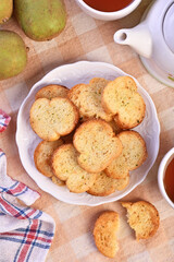 Round rusks with pesto sauce flavor on white plate  