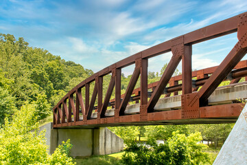 Metal steadfast vehicular truss bridge over small river