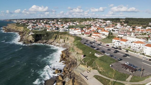 Aerial view of Praia das Macas little township along south Portuguese coastline facing the Atlantic Ocean, Colares, Portugal.