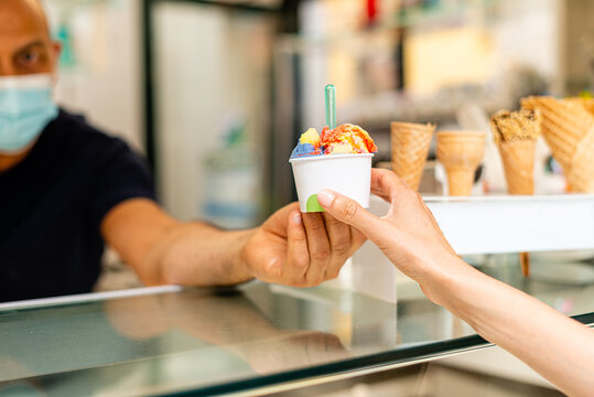 Bartender Man Passing Big And Colorful Icecream Cup To Woman Close Up Scene