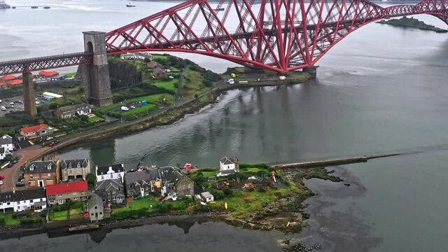Aerial panning view from North Queensferry across the Firth of Forth and the Forth Rail Bridge - Scottish UNESCO World Heritage Site.