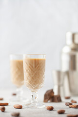 Chocolate cream alcohol liqueur in a glass, pieces of chocolate and cocoa beans.