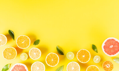 Summer composition made from oranges, lemon or lime on pastel yellow background. Fruit minimal concept. Flat lay, top view
