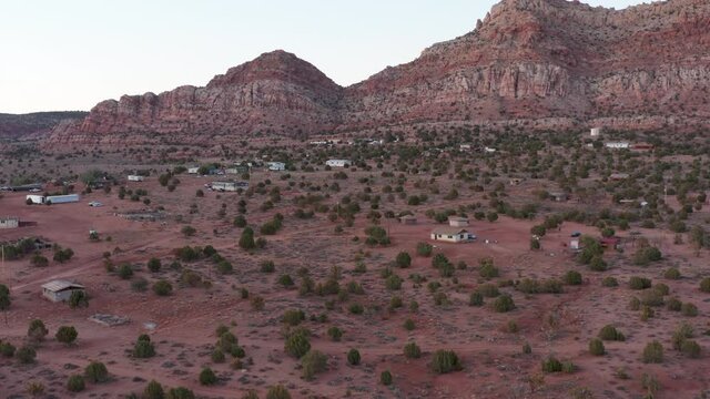 Flying above a Navajo community near mountain ridge. Near Tuba City, AZ.