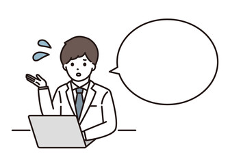 パソコンの前で困りながら説明をする男性薬剤師