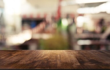 Empty dark wooden table in front of abstract blurred background of cafe and coffee shop interior. can be used for display or montage your products.