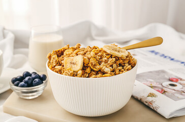 Bowl with tasty granola on table