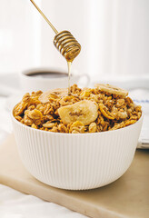Bowl with tasty granola on table
