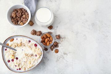 Obraz na płótnie Canvas Tasty granola with milk on light background