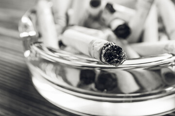 Many cigarettes in ash tray, closeup. Concept of addiction